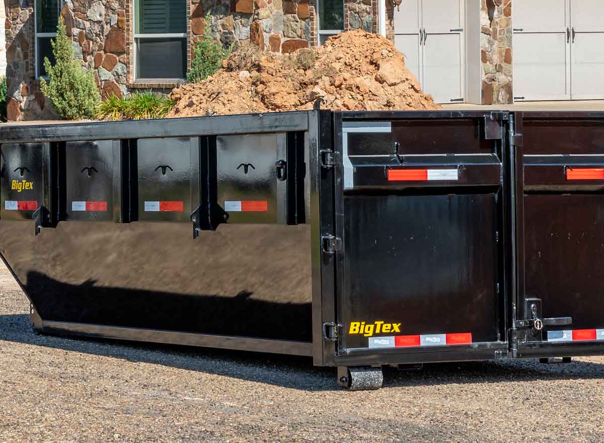 Big Tex dump trailer loaded with a pile of dirt