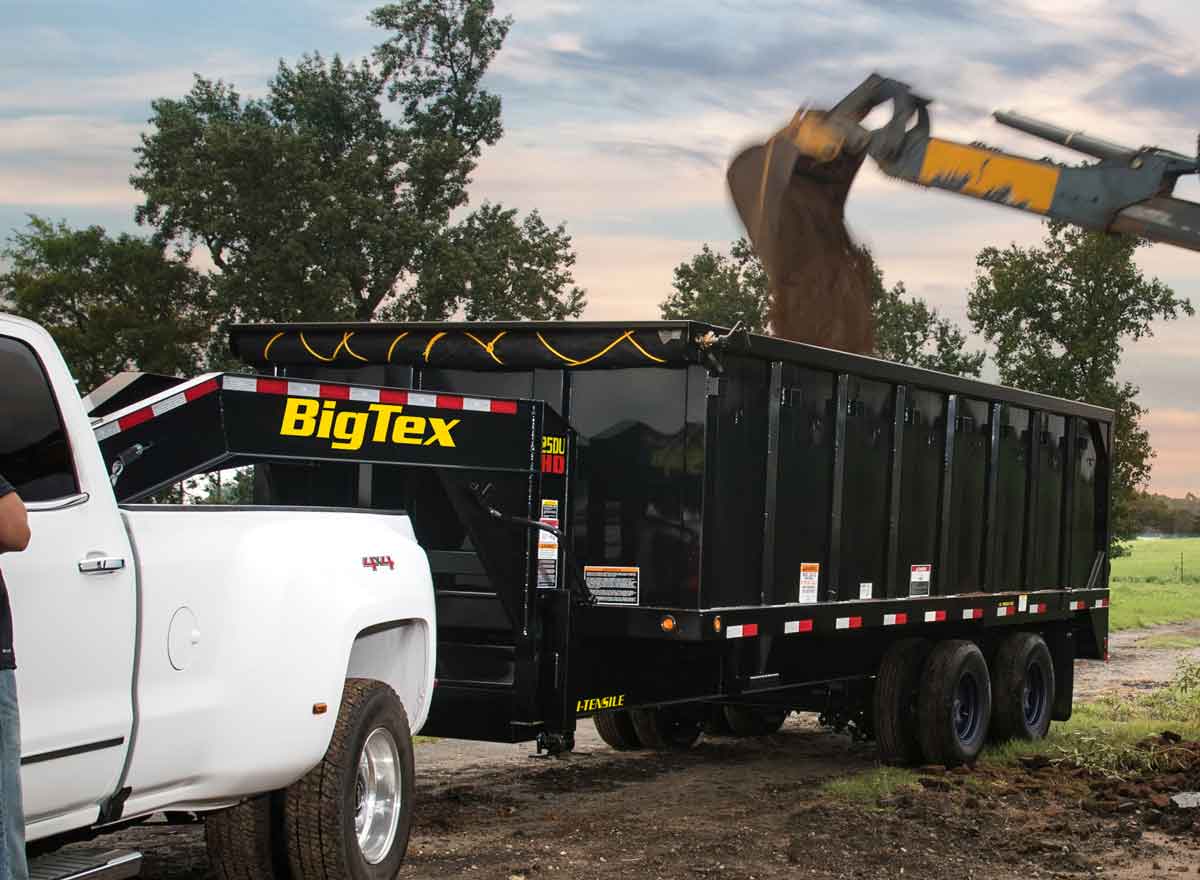 Big Tex dump trailer is being loaded with dirt