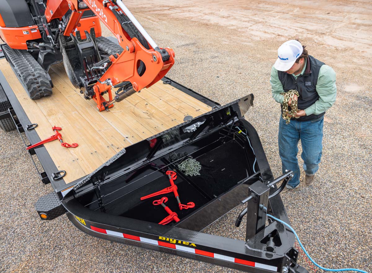 a man standing next to a trailer with a mega sized toolbox